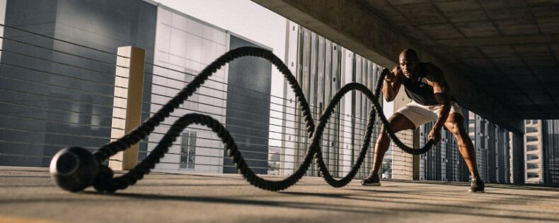 Man using battle ropes