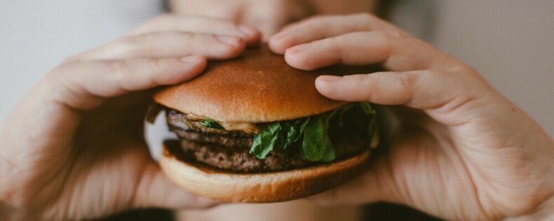 A person eating a burger