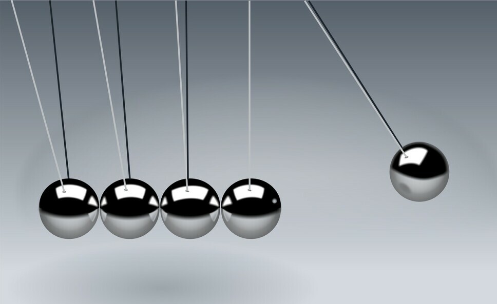 Newton's cradle, which demonstrates the conservation of momentum